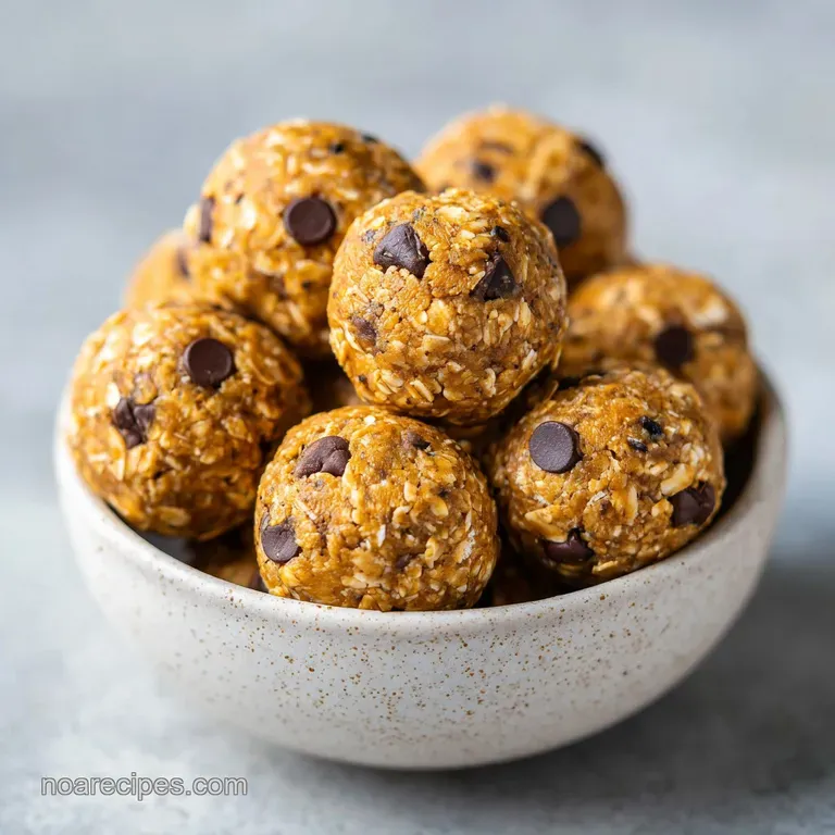 Three textured oat spheres stacked neatly on a white ceramic plate, accented with a fresh, green mint sprig.